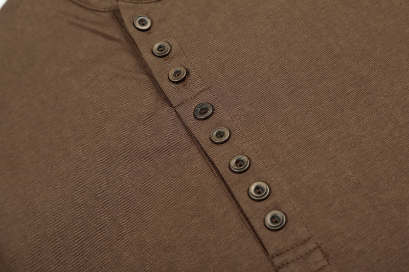 Close-up of brown Henley T-shirt button placket stitching and buttons