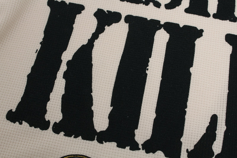Close-up of the Villa lettering in the front graphic on cream waffle knit fabric