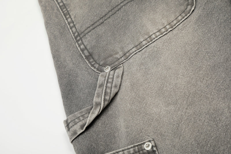 Close-up of gray carpenter jeans side utility loop and pocket snap detail