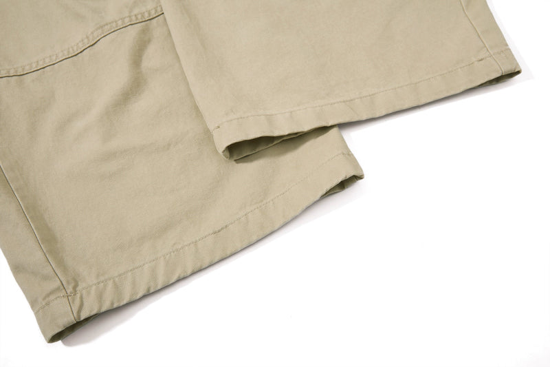 Close-up of beige pant hem with straight stitched cuff