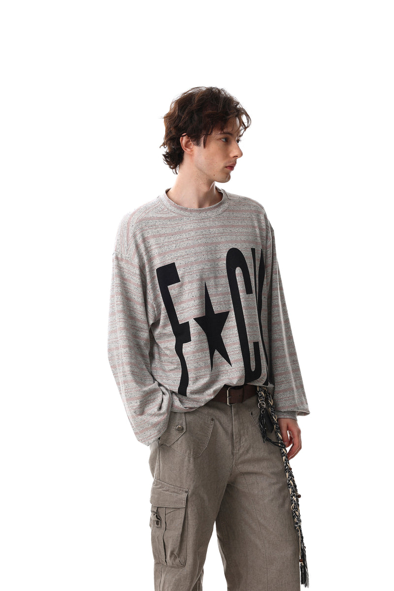 Model wearing gray striped long sleeve crewneck tee with oversized black front graphic