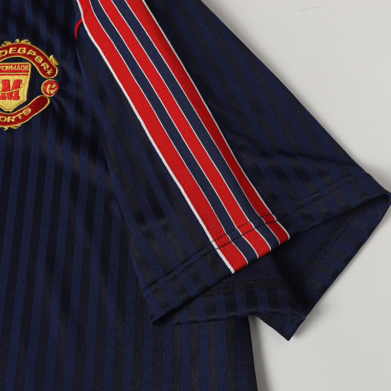 Navy striped soccer jersey with red and white sleeve accents and embroidered crest detail