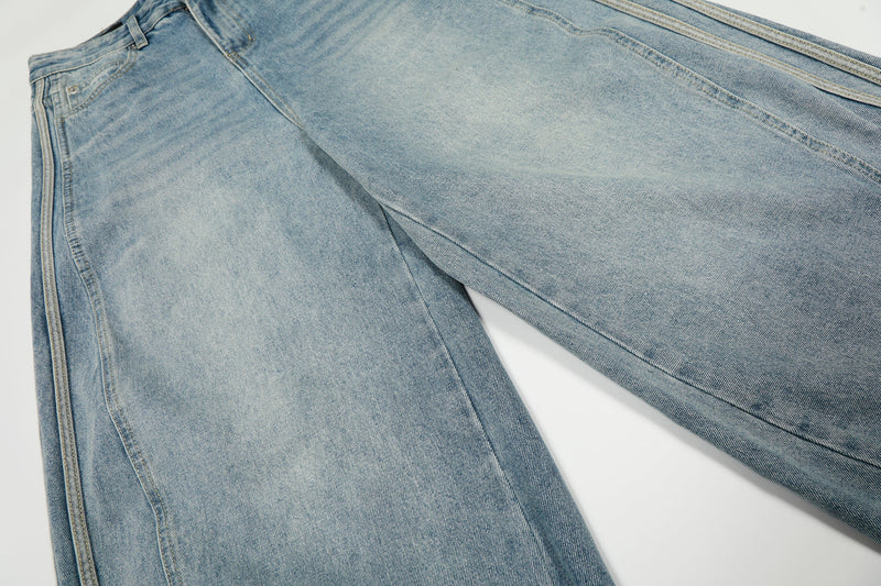 Close-up of light wash denim leg panel showing oversized wide-leg shape