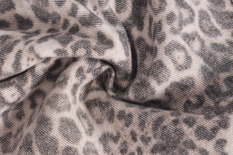 Close-up of leopard print denim fabric with soft folds and texture