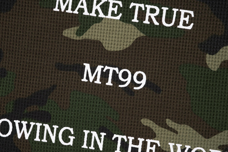 Close-up of front text print on camo sweatshirt reading MAKE TRUE MT99