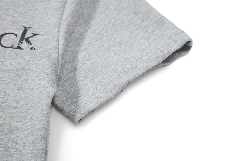Light gray graphic polo tee with black distressed lettering on soft cotton fabric, shown in close-up on a white background