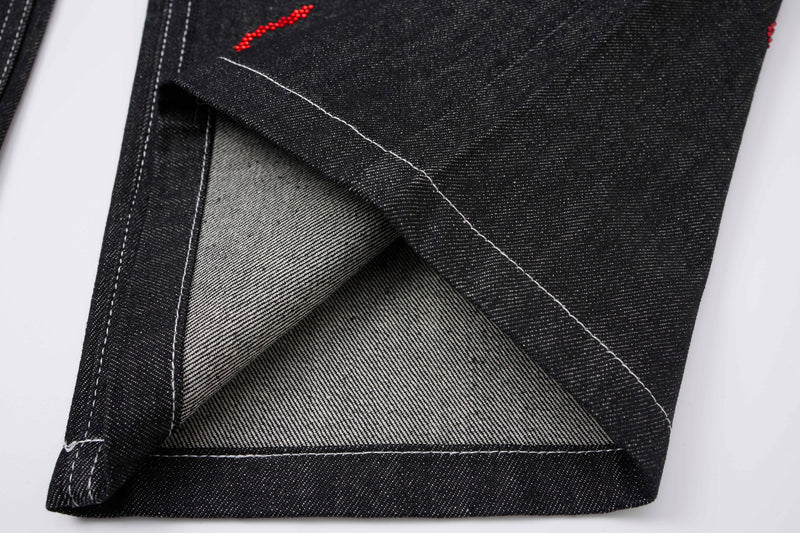 Folded hem detail showing black denim lining and contrast topstitching