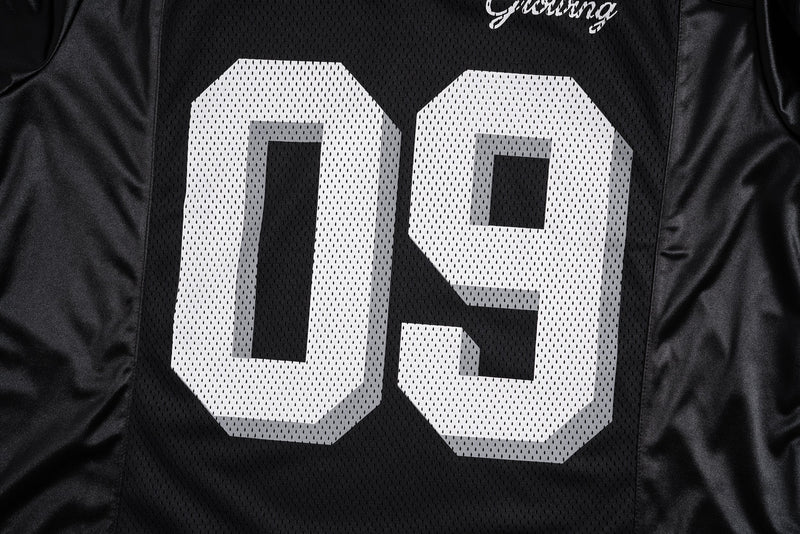 Close-up of the front chest with large white 09 on black mesh jersey