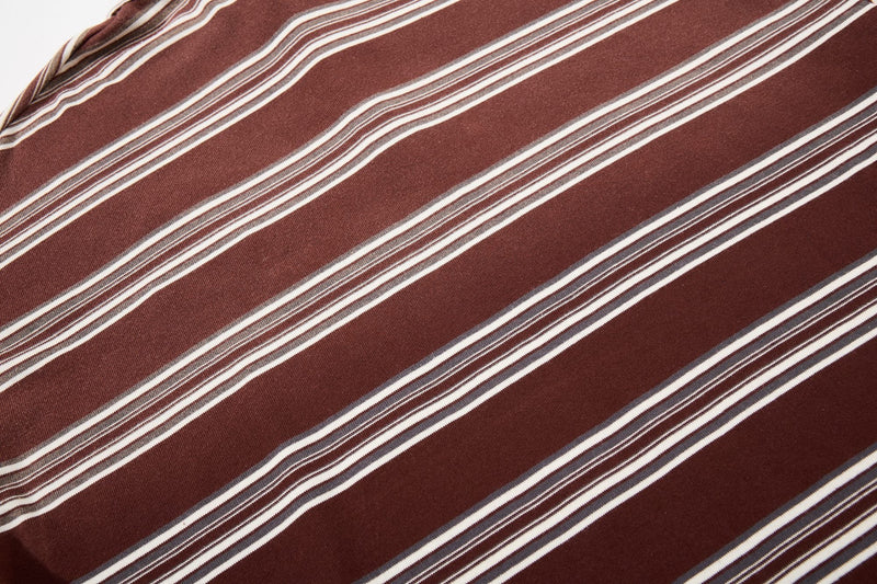 Brown vintage rugby polo shirt with diagonal white and tan stripes, retro 90s style fabric close-up