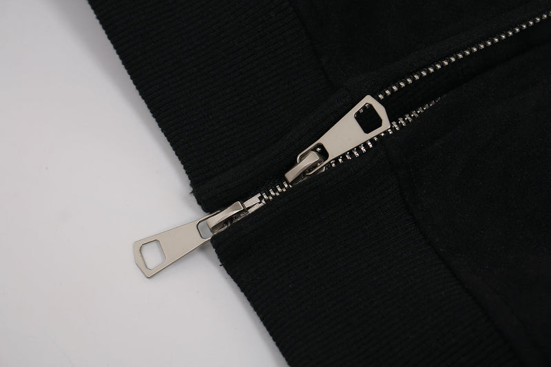 Close-up of metal front zipper pull on black ribbed hoodie trim