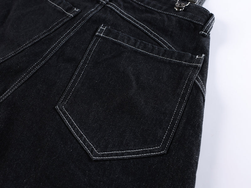Close-up of black denim back pocket with white contrast stitching