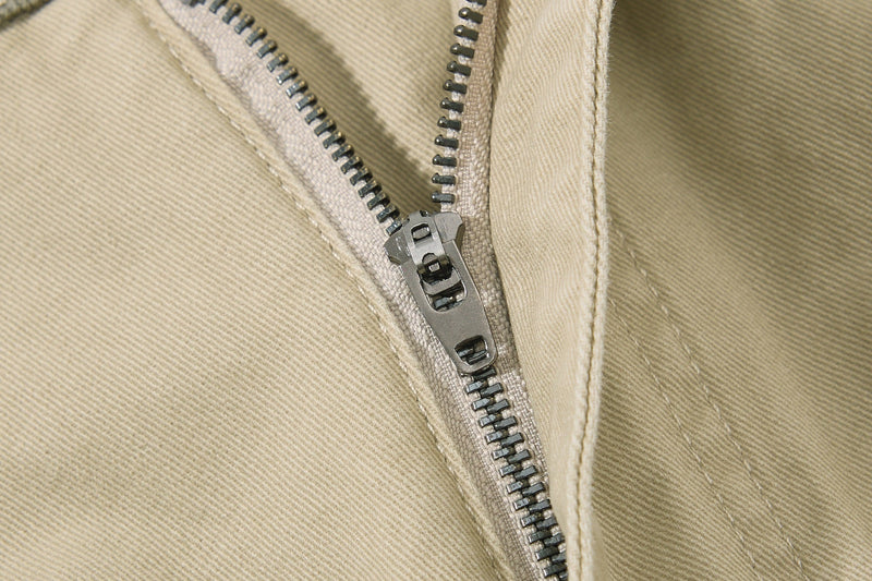 Close-up of beige zipper fly and front seam detail