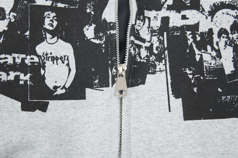 Close-up of light gray hoodie front zipper and black collage graphic