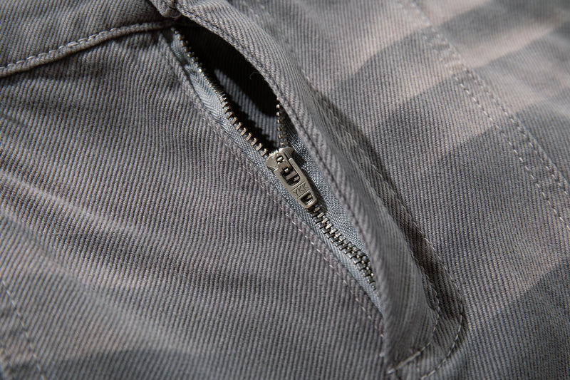 Close-up of gray jeans zipper fly with metal zipper pull and front seam