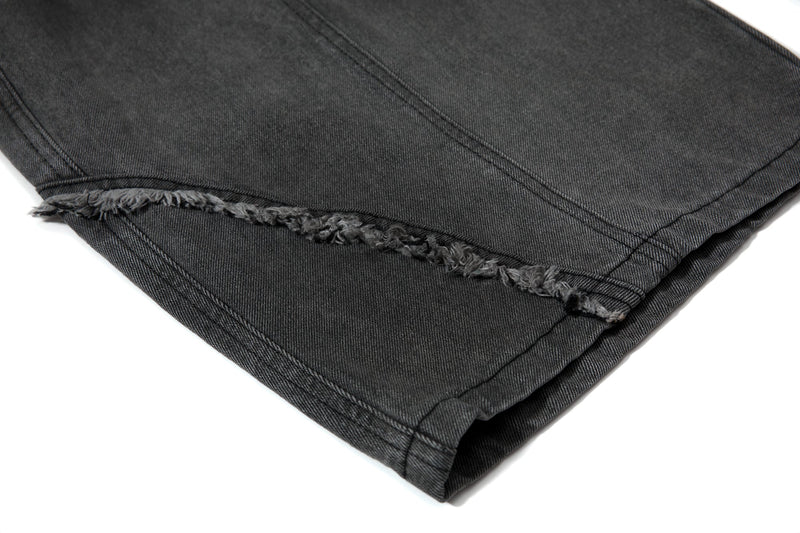 Close-up of bottom hem with frayed edge on black wide-leg jeans