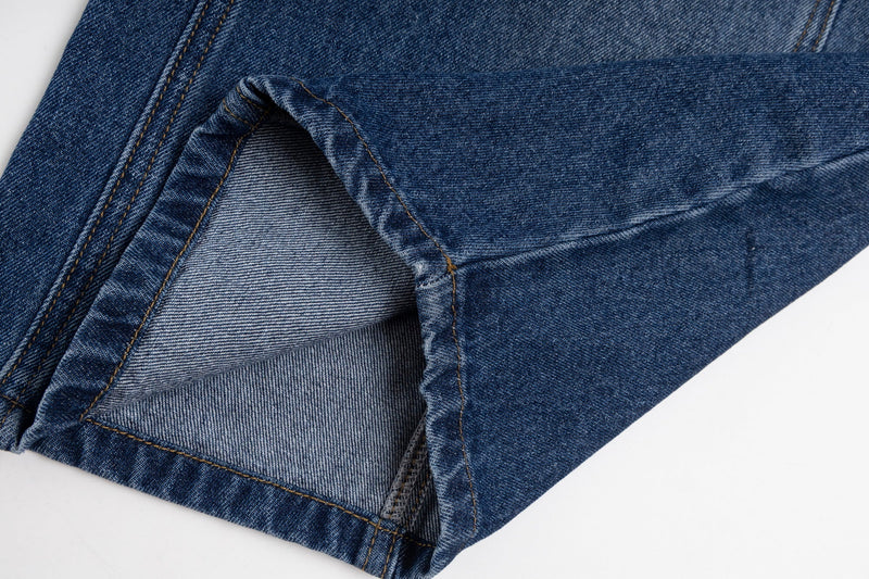 Close-up of blue jeans cuff showing inside seam and denim texture