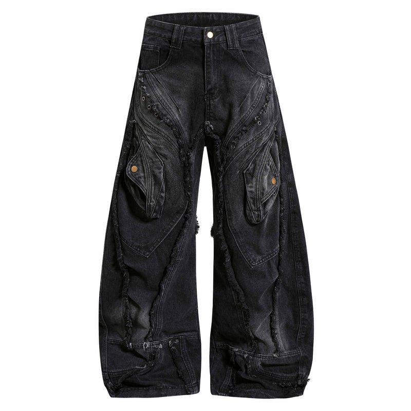 Front view of black wide-leg denim jeans with distressed paneling and metal rivet details
