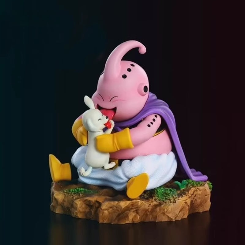 The Majin Buu Collectible Figure by Seakoff, standing at 8.5cm, features the pink character with a curled antenna, purple cape, and white pants hugging a small bunny on a rocky base—an ideal piece for anime fans.