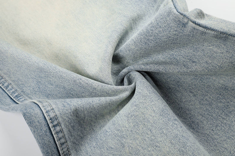 Close-up of light wash denim fabric texture and seam stitching