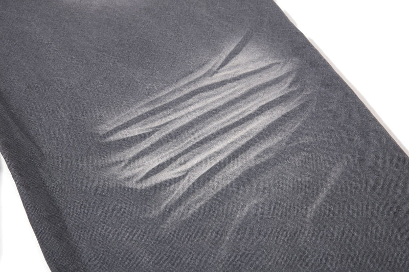 Close-up of charcoal denim faded wash texture