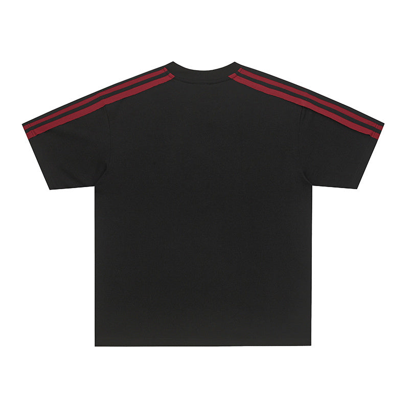 Black cotton tee with red triple stripes on the shoulders, featuring a relaxed streetwear fit and crew neckline