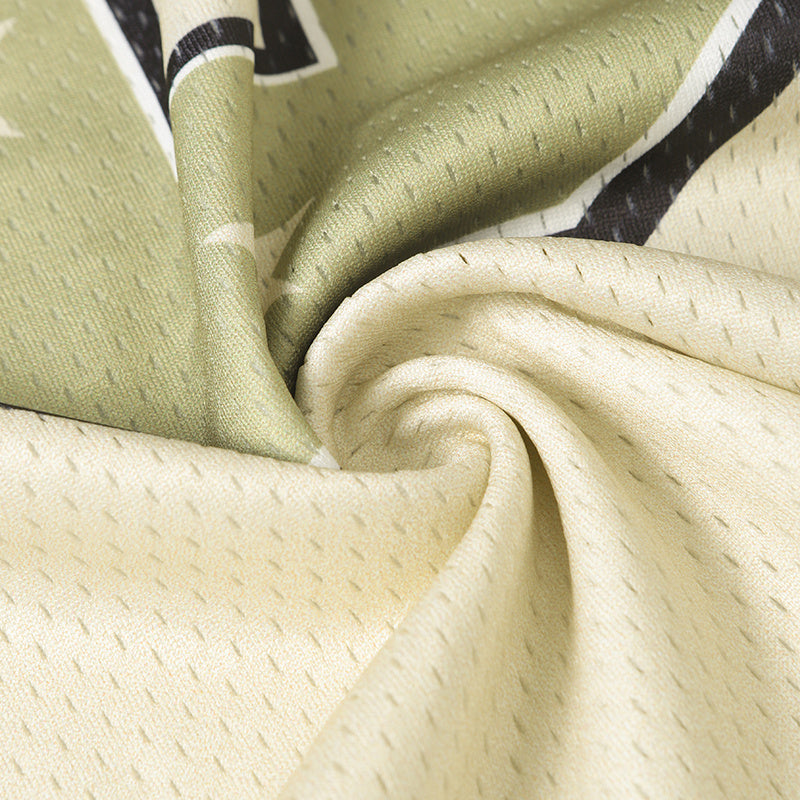 Close-up of breathable camo football jersey fabric in olive and beige with a textured mesh finish