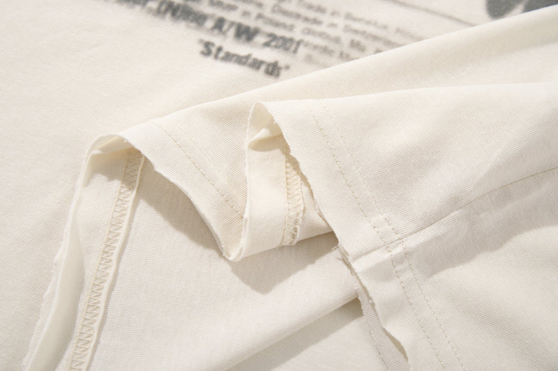 Close-up of long sleeve cuffs and side seam on cream tee