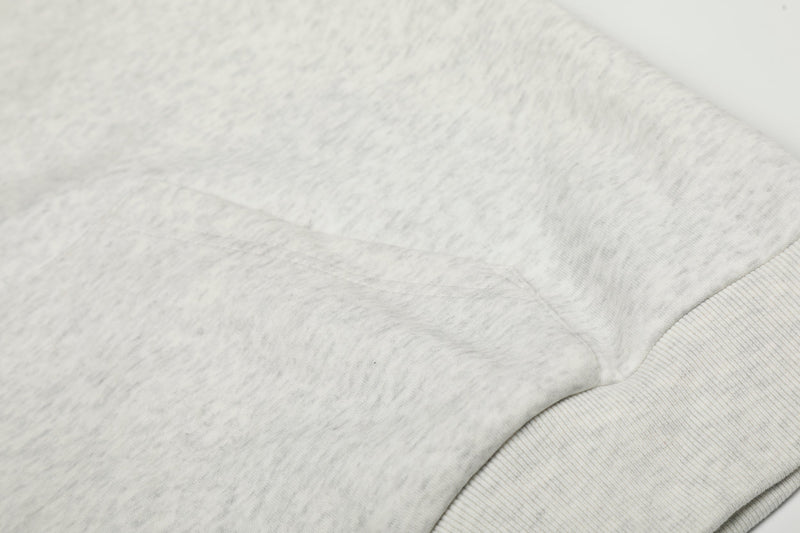 Close-up of light gray hoodie shoulder and fabric texture