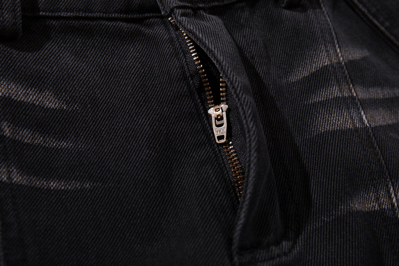 Close-up of zipper fly on dark denim jeans with visible metal zipper teeth