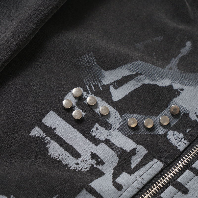 Close-up of front graphic with metal studs and zipper on black washed hoodie