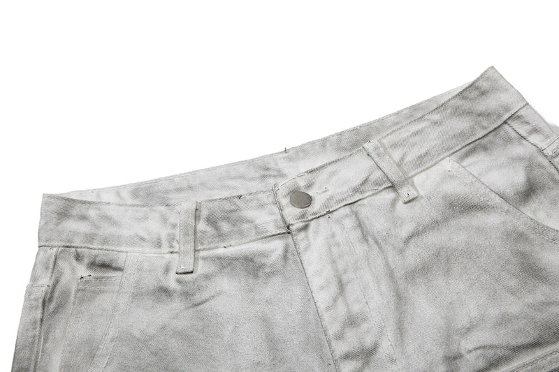 Close-up of light gray jeans waistband with button and belt loops