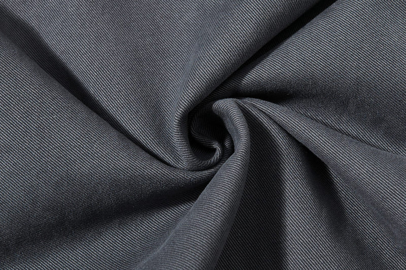 Close-up of dark gray fabric swirl with fine twill texture