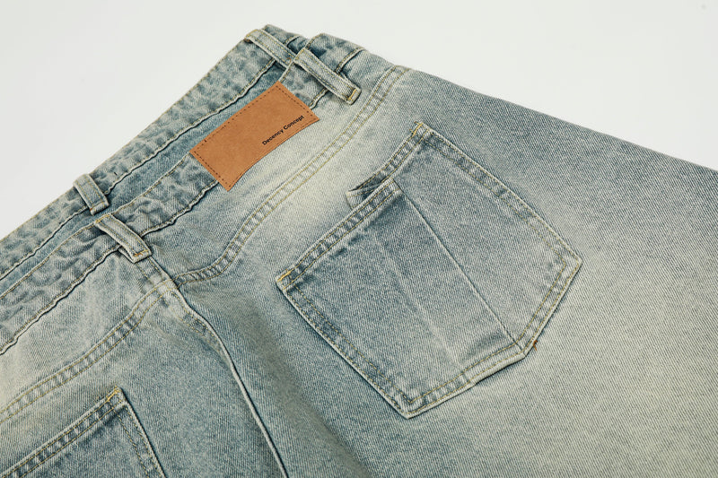 Close-up of back waistband, patch label, and pocket on light wash denim jeans