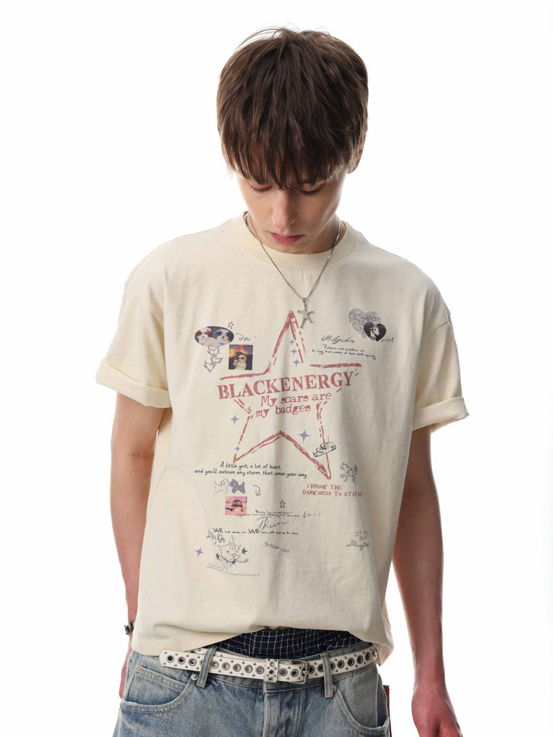 Oversized cream cotton tee with Blackenergy star graphic, worn with relaxed jeans and a studded belt on a model