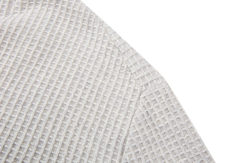 Cream waffle knit short-sleeve sweater with ribbed texture and relaxed fit on a white background