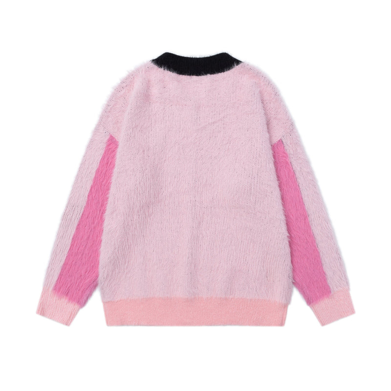 Back view of pink fuzzy knit sweater with black collar, pink side panels, and ribbed hem