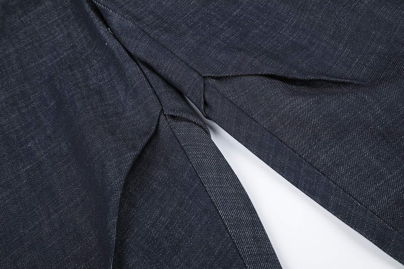 Close-up of overlapping dark denim panels at the waist and upper leg