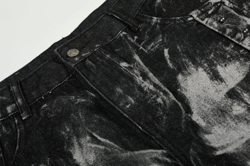 Close-up of black denim front waist and button area with painted finish