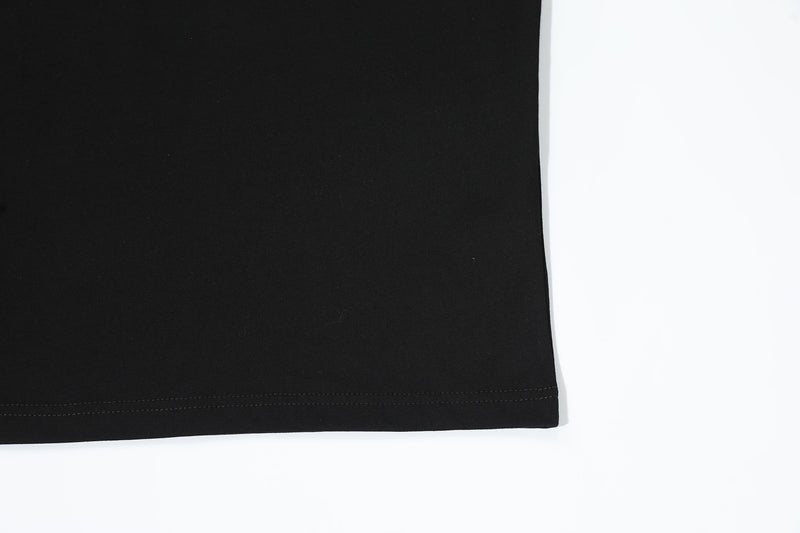 Black oversized T-shirt hem with double stitching on a clean white background