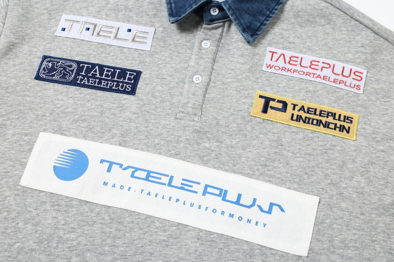 Close-up of front chest patches and button placket on gray sweatshirt
