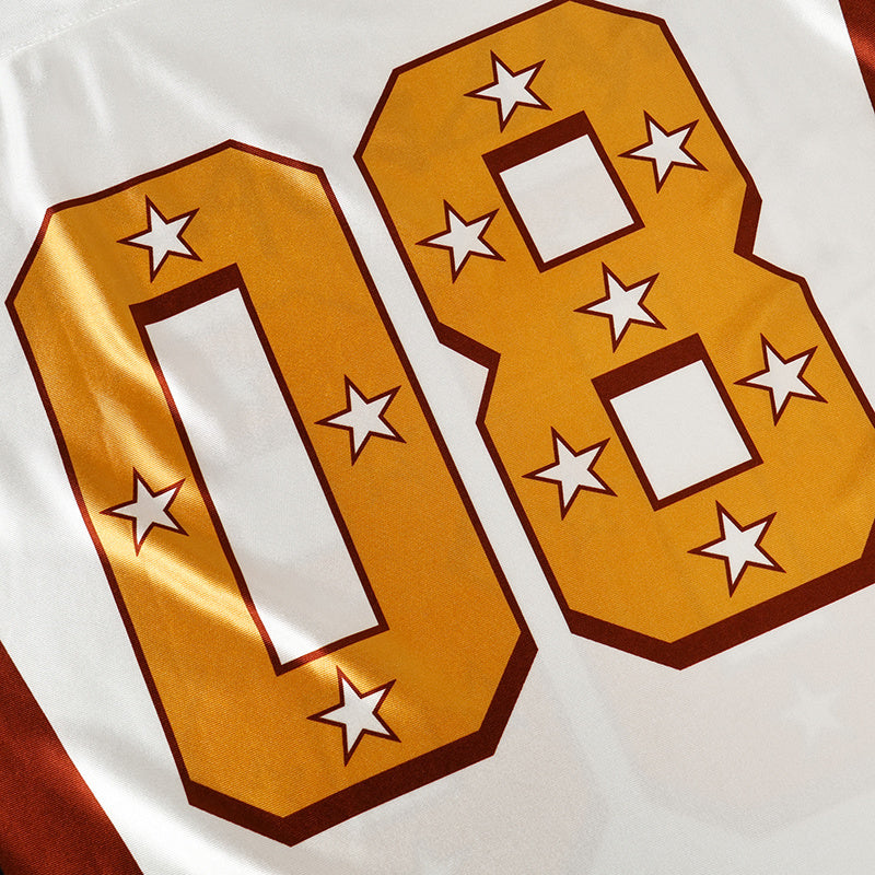 White football jersey featuring oversized gold 08 star number print and maroon trim, close-up streetwear detail