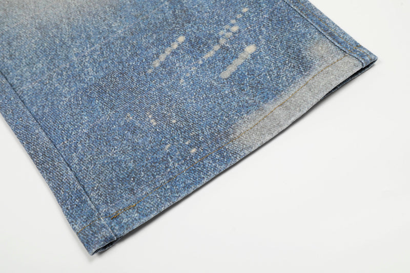 Close-up of the hem on faded blue wide-leg denim jeans
