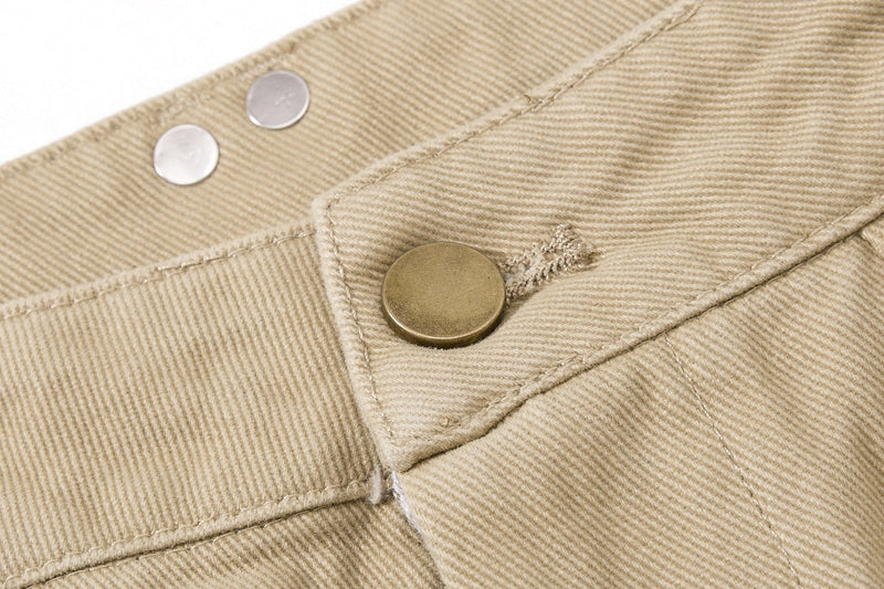 Close-up of khaki waistband snap button and textured twill fabric