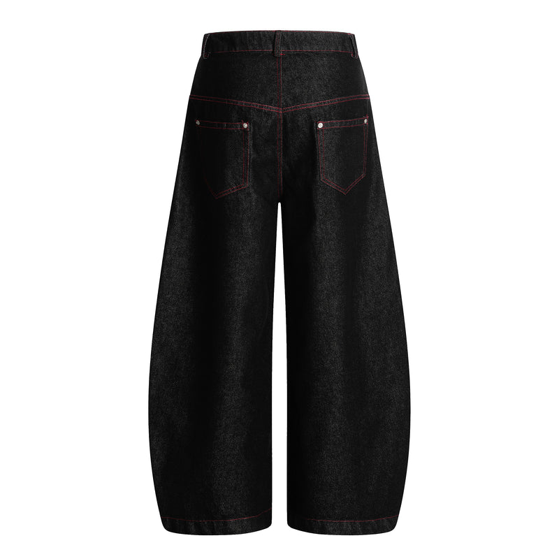 Back view of black wide leg denim pants with red stitching and back pockets