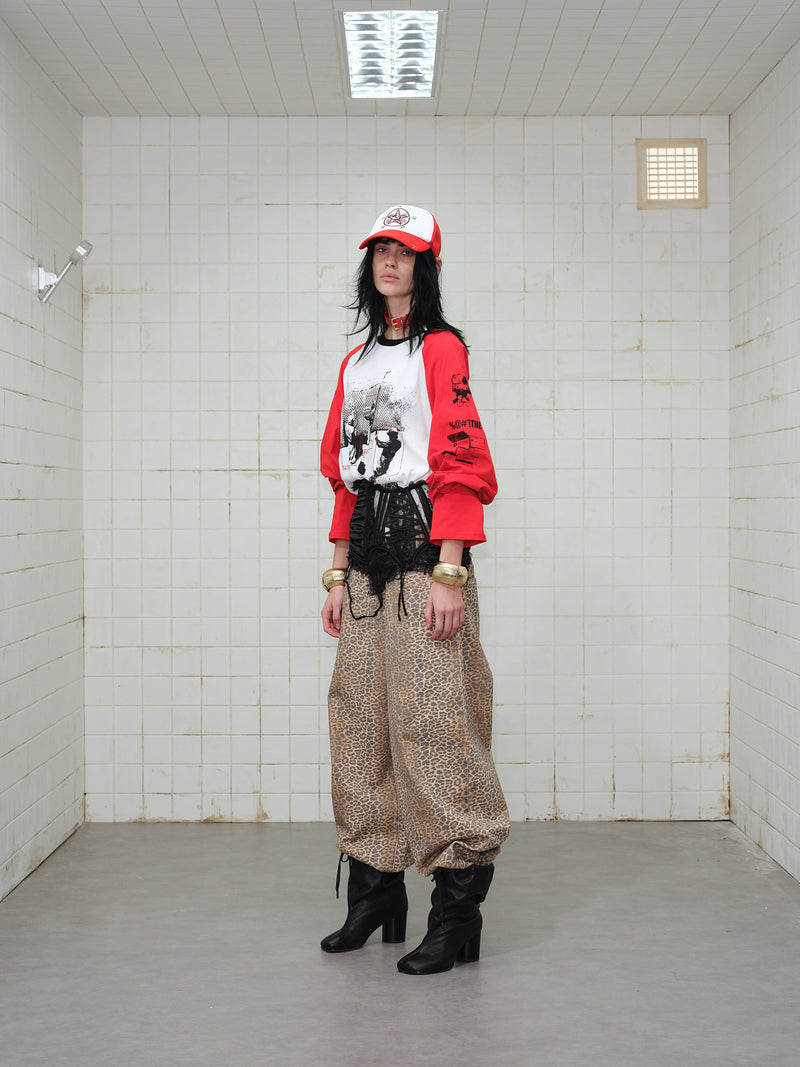 Side view of model wearing red and white graphic raglan long-sleeve T-shirt
