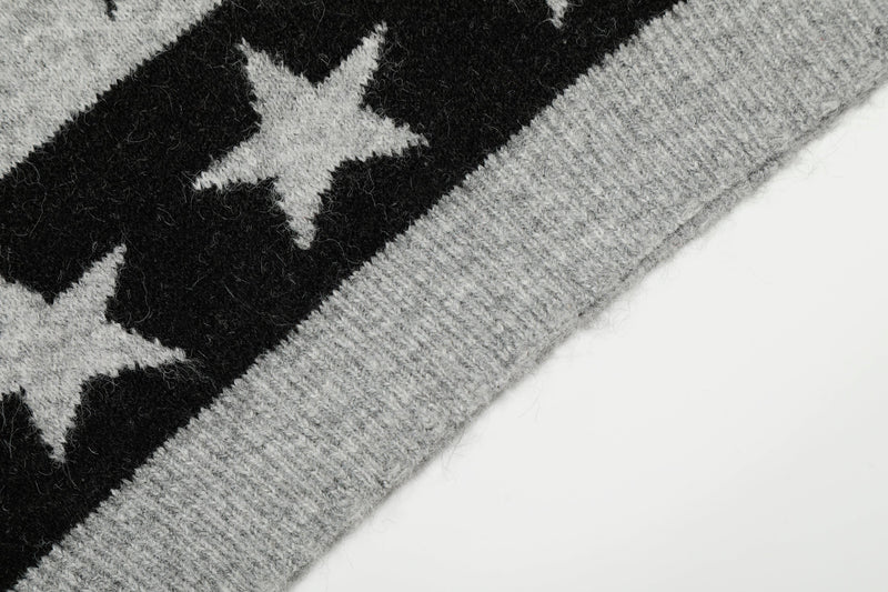 Close-up of gray sleeve and black star pattern on knit sweater