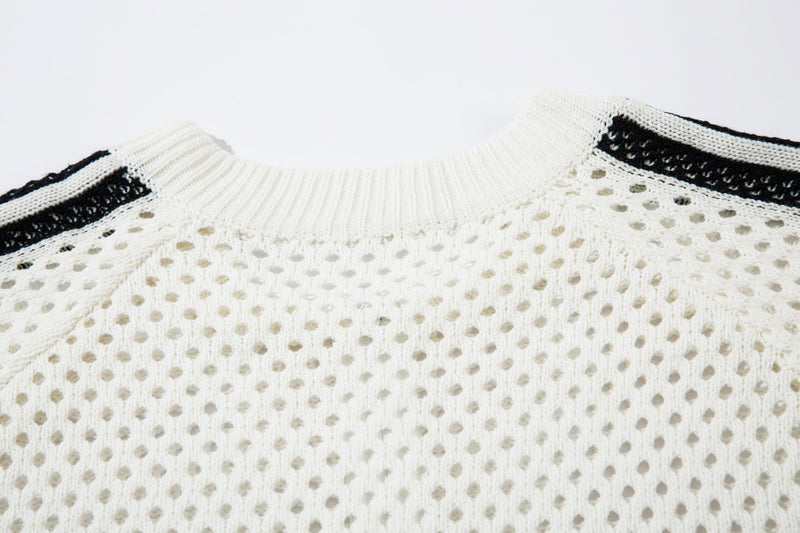 Close-up of white ribbed collar and black shoulder stripe detail