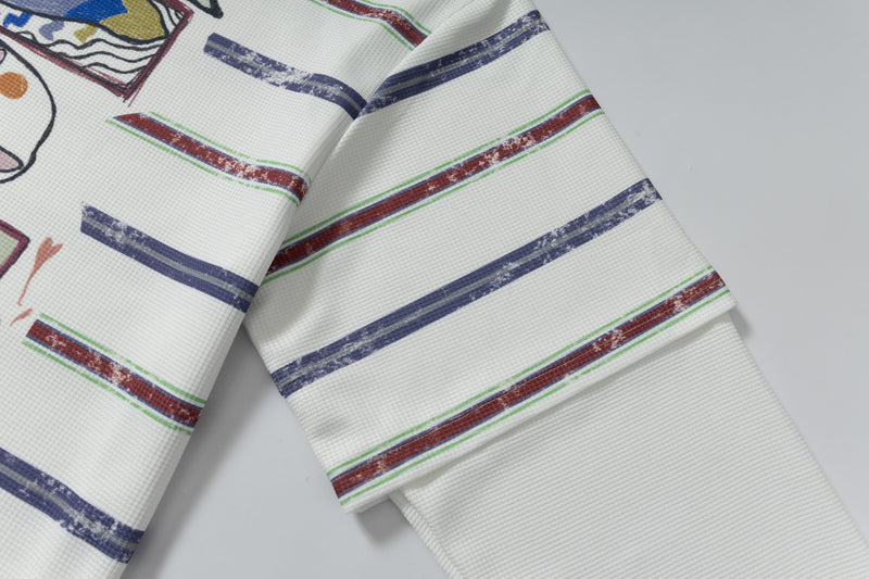 Close-up of striped sleeve on white long-sleeve polo shirt