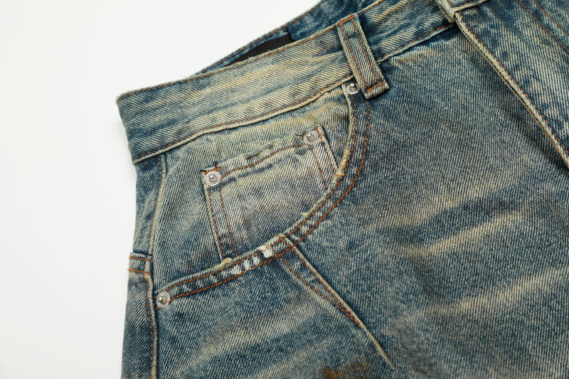 Close-up of front pocket and coin pocket on distressed blue denim with faded wash