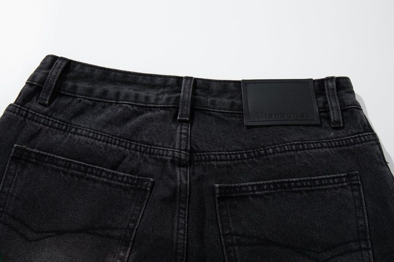 Close-up of the back waistband on washed black jeans with black leather brand patch